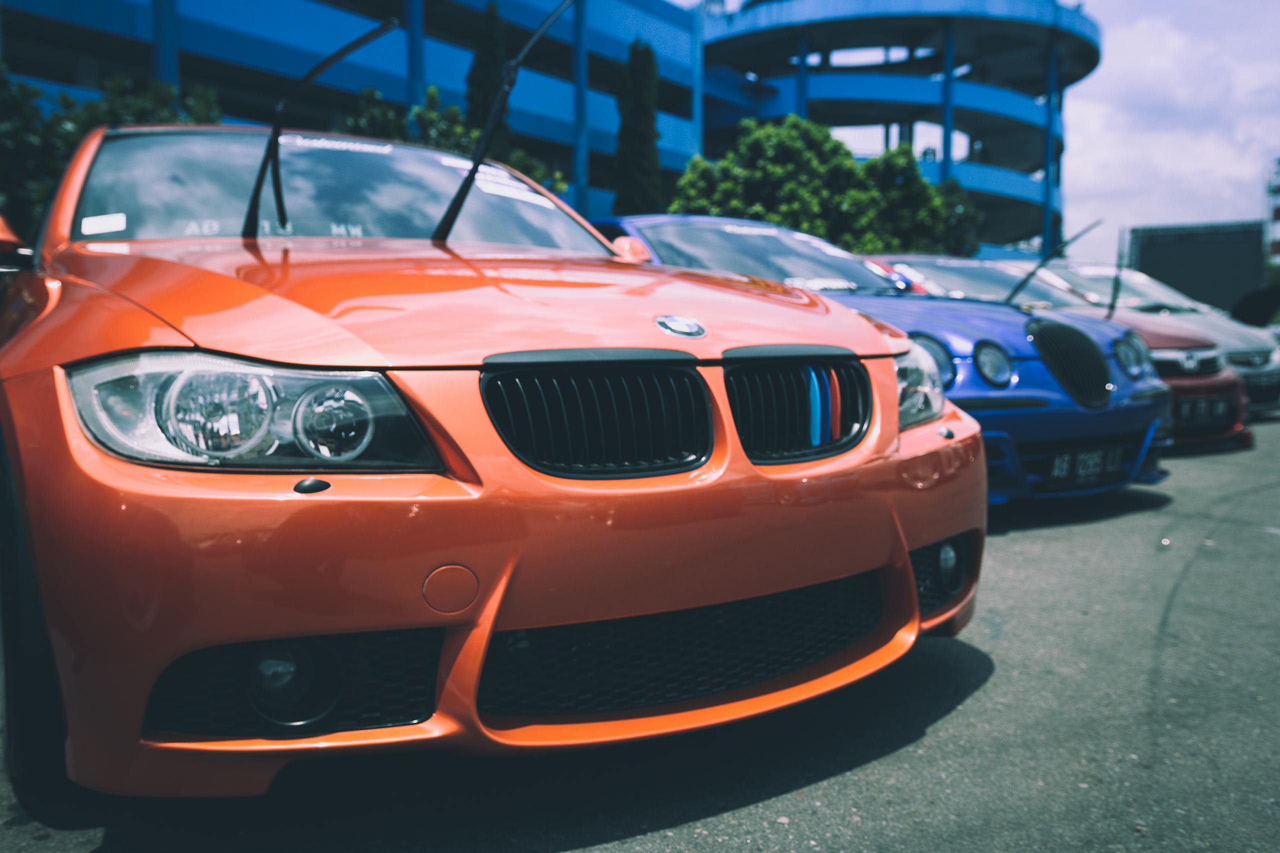 Vibrant BMW cars parked outdoors showcasing an array of colors and designs.